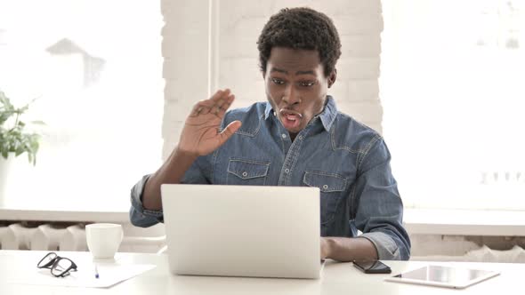 Online Video Chat on Laptop By African Man alt