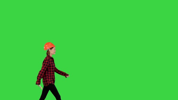 Asian Engineer Walking with Blueprints on a Green Screen Chroma Key