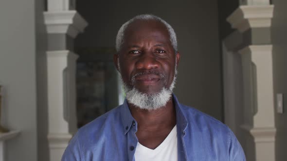 Portrait of african american senior man smiling at home alt