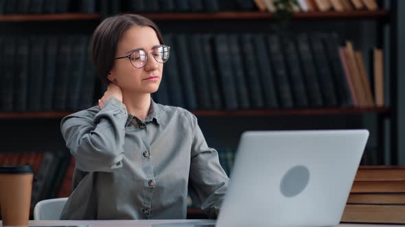 Unwell Business Woman Working Library Laptop Feeling Neck Pain Workaholism Sitting at Library Desk alt