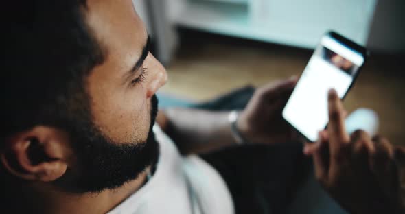 Man Scrolling Social Network on Phone