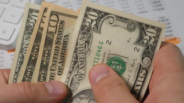 Dollar Bills in Men's Hands