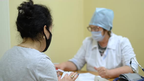 Female Patients Undergoing Questioning with Coronavirus Nurse During Pandemic alt