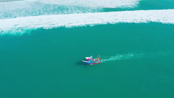 Fishing Boat Floating on Ocean Waves Near Shore