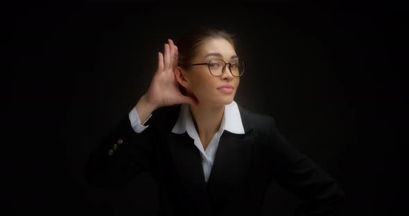 Beautiful Brunette in Business Clothes and Glasses Asks to Speak Louder