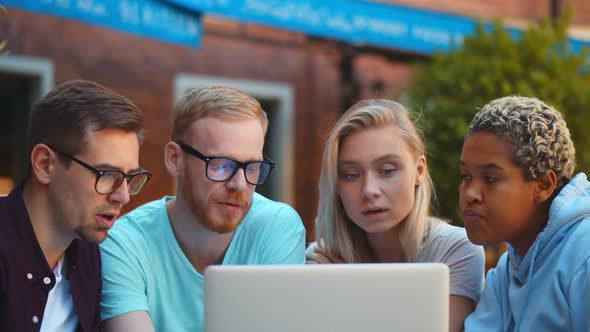 Interracial Students Friends Using Laptop Outdoors, Checking Results Of Their Exams alt