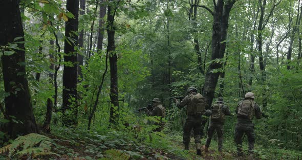 Soldiers Moving Through Forest During Tactical Action Concept of War and Attacking alt