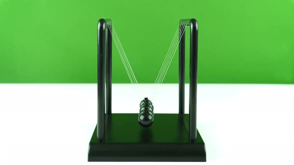 Table Pendulum Small Newton Balls On A Green White Background 3.