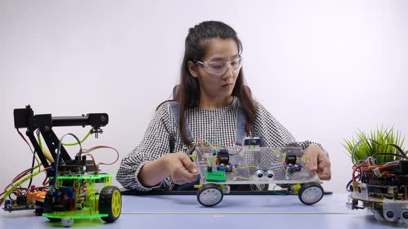 Robotics Engineers or student testing a robot. Innovative technology mechanical alt