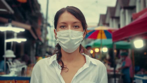Portrait of a Young Tourist Woman Wearing Protective Mask on Street Crowd People alt