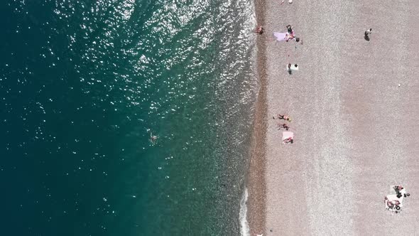 People on beach top view alt