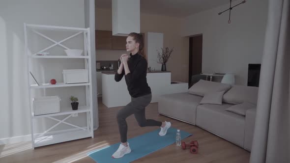 Sporty Young Woman Doing Squat Morning Exercise Alone in Living Room Serious Fit Girl Wearing alt