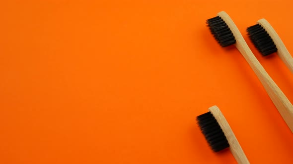 Toothbrushes on Orange Background alt