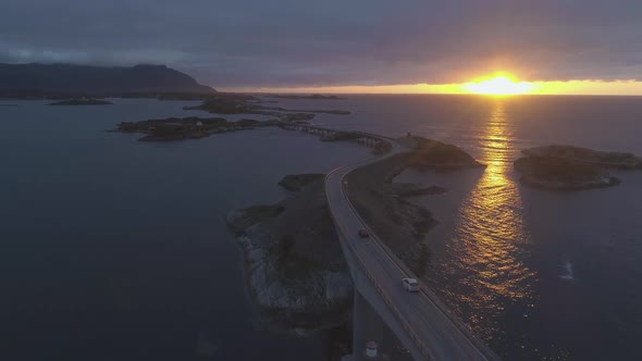 Atlantic Ocean Road in Norway at Sunset. Cars Are Passing on Storseisundet Bridge. Aerial View alt
