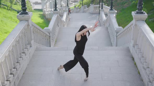 Top View of Charming Young Ballerina Walking on Tiptoes, Sitting Down on One Knee and Bending alt
