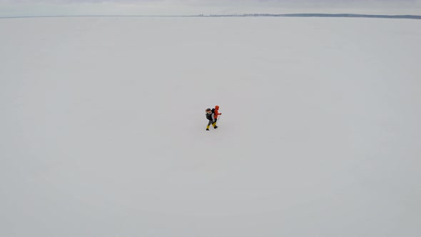 Aerial View of Two Male Hikers Walking in Untouched Snow Landscape. Aventures Journey Trip Scenery alt
