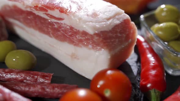 Assorted Deli Meats, Ham, Salami, Bacon and Tomatoes on the Black Stone Tray alt