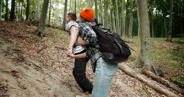 Couple Going Uphill in Forest