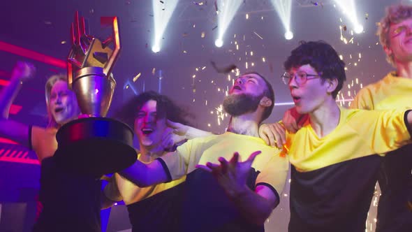 Young Gamers Celebrating Victory Under Confetti alt