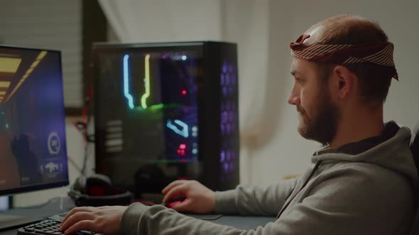 Pro Gamer Man Sitting at Powerful Personal Computer alt