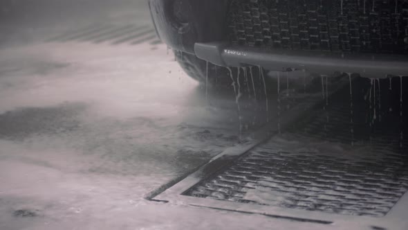 Water with Detergent Dripping From Car Bumper