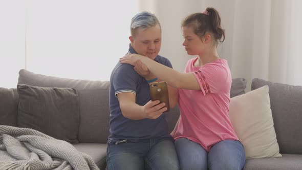 Young Couple with Down Syndrome Taking a Selfie