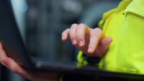 Closeup Hands Typing Laptop Computer on Modern Facility alt