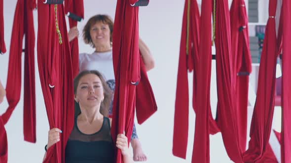 Pretty Dark Haired Woman Relaxes After Fly Yoga Workout alt