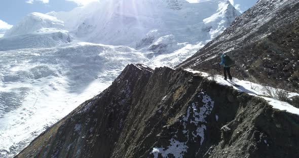 Woman backpacker climbing mountains in winter nature  alt
