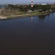 Drone is Flying Over the Black Sea to Poti Georgia Lighthouse on the Shore