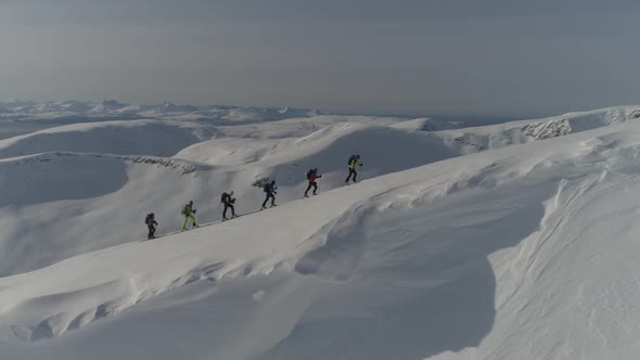 Caravan Of Skiers On Mountain Ridge