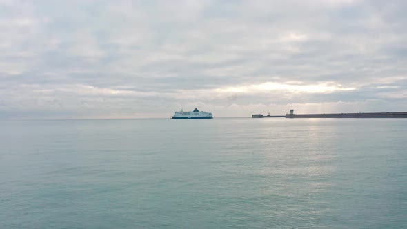 Low aerial drone shot towards Dover to calais cross channel ferry leaving dover harbour alt