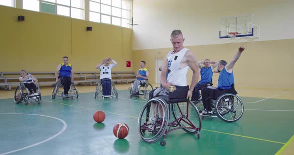 Persons with Disabilities Stretching Before a Basketball Game in the Modern Hall alt