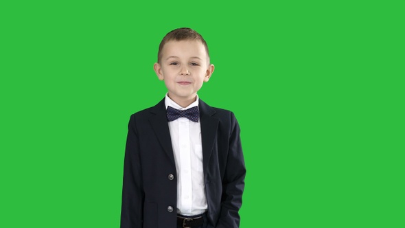 Boy in formal costume walking with a hand in pocket on alt