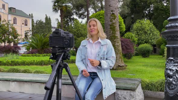 Blogger Filming Herself on Camera in the Garden