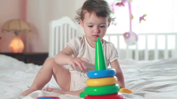Baby Playing with a Toy Pyramid alt