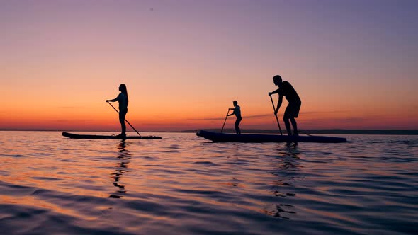 Girl and Boys Supping on Water in the Evening. alt