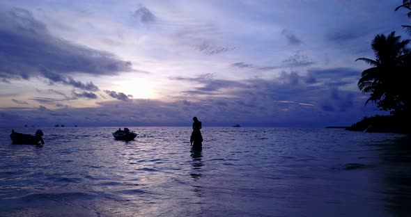 Young lady and man in love dating on vacation have fun on beach on white sand 4K background alt