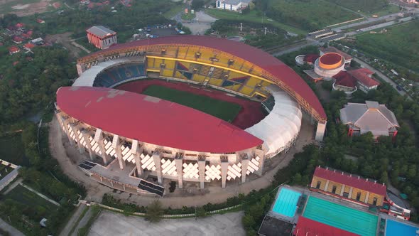 Aerial top down view of the Beautiful scenery of Wibawa Mukti Stadium when sunrise alt