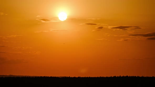 Dramatic Sunset with Sun Rays in Sky Through Orange Layered Clouds Timelapse alt