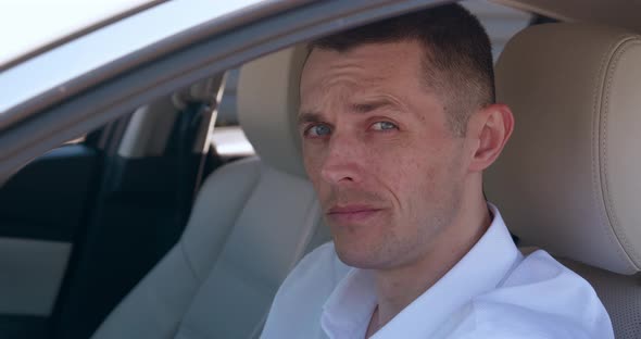 Portrait of Mature Ceo Executive Sitting in a Car on Drivers Seat alt