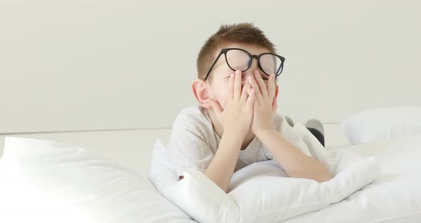 Portrait child boy With Glasses Looking at Camera. Laughs Happily toothless kid with Glasses 