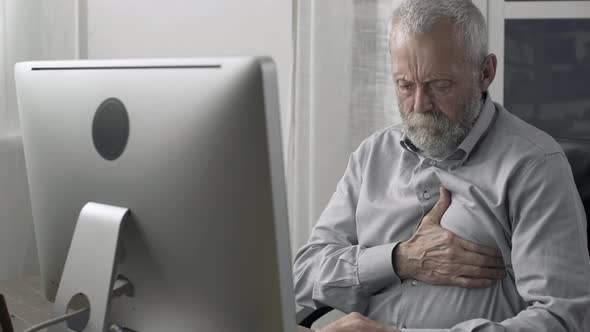 Senior man having an heart attack at home