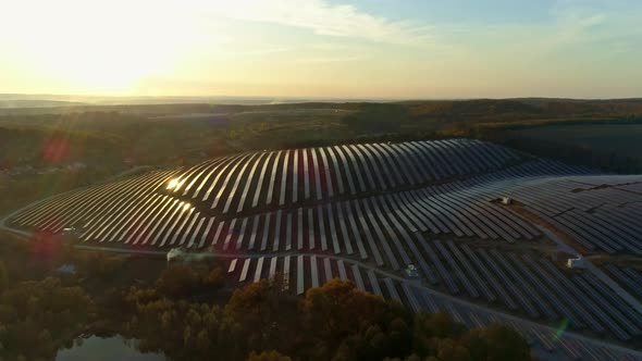 Aerial Drone Footage. Flight To Solar Station Farm at Sunset Autumn Season