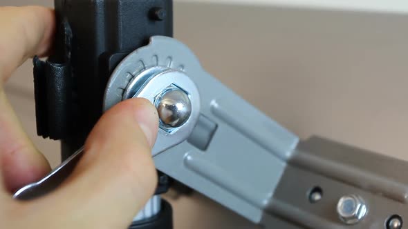 Close-Up of Hands Tightening Nut Fastener with A Hexagonal Ratchet Wrench alt