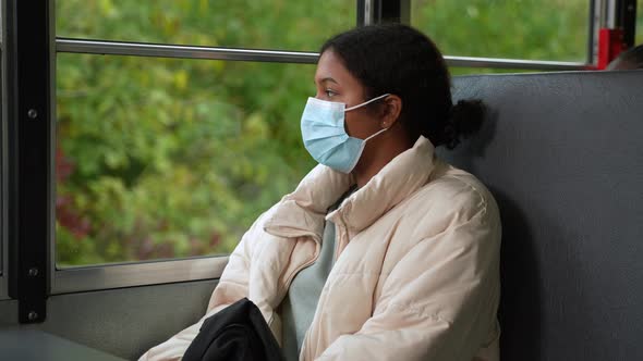 Indian Girl Student in Face Mask Riding School Bus alt