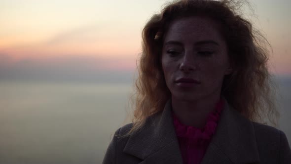 Close Up Shot of Beautiful Young Caucasian Woman with Curly Blond Hair and Freckles Looking at alt