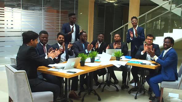 Success International Group of Ten Excited Young Business Team Throwing Away Papers and Hands Shake alt