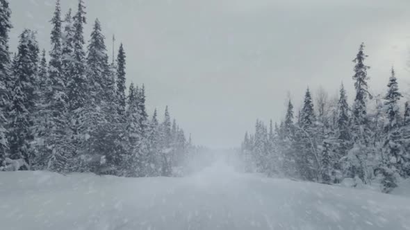 Driving on an Empty Winter Road and Snowfall