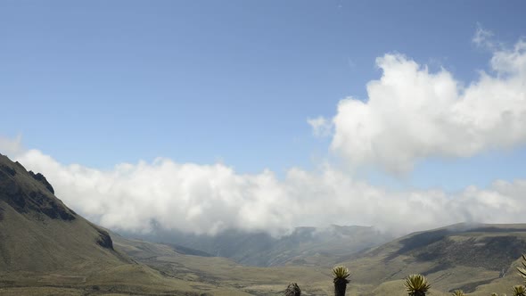 Time lapse of low clouds moving over arid mountain landscape alt